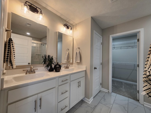 1204 Boulder Pass Rd, Clarksville, TN 37040 - full bath featuring marble look tile flooring, a shower stall, double vanity, a spacious closet, and a textured ceiling