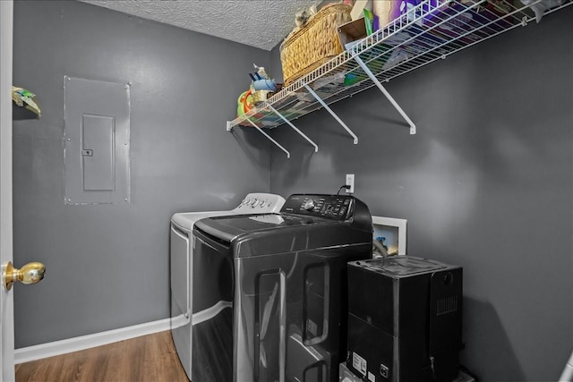 7173 New Hope Rd, Fairview, TN 37062 - laundry room with electric panel, washing machine and dryer, and wood finished floors