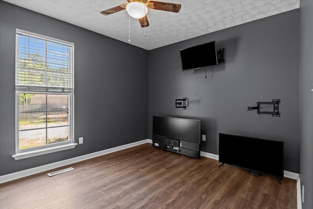 7173 New Hope Rd, Fairview, TN 37062 - unfurnished living room featuring wood finished floors, ceiling fan, and a textured ceiling