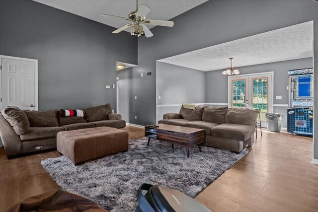 7173 New Hope Rd, Fairview, TN 37062 - living area with high vaulted ceiling, wood finished floors, a ceiling fan, and a chandelier