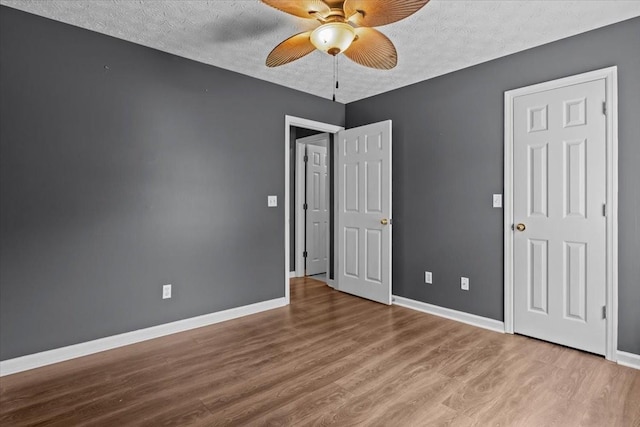 7173 New Hope Rd, Fairview, TN 37062 - unfurnished bedroom with a textured ceiling, wood finished floors, and a ceiling fan