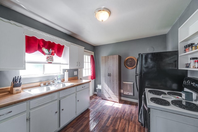 1532 Santa Fe Pike, Columbia, TN 38401 - kitchen with white electric range oven, dark wood-style flooring, freestanding refrigerator, white cabinetry, and wood counters