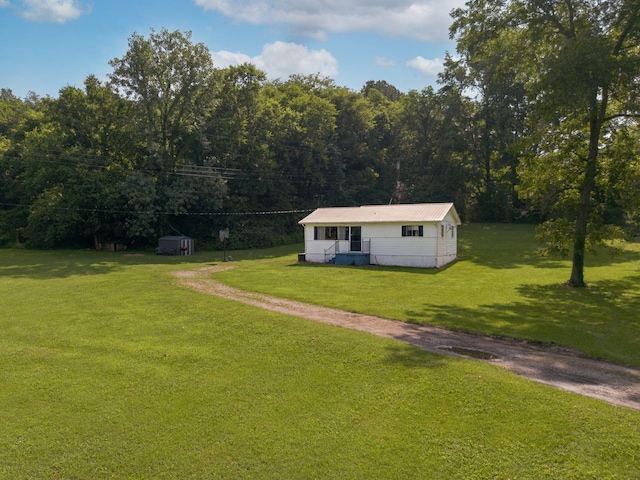 1532 Santa Fe Pike, Columbia, TN 38401 - view of front of home with a front lawn, a storage shed, and a forest view