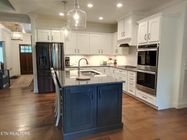 115 Bent Oak Ter, Crossville, TN 38558 - kitchen featuring appliances with stainless steel finishes, recessed lighting, white cabinetry, ornamental molding, and a kitchen island with sink
