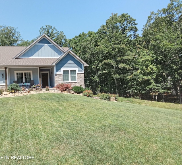 115 Bent Oak Ter, Crossville, TN 38558 - view of front facade with a front yard, stone siding, covered porch, and board and batten siding