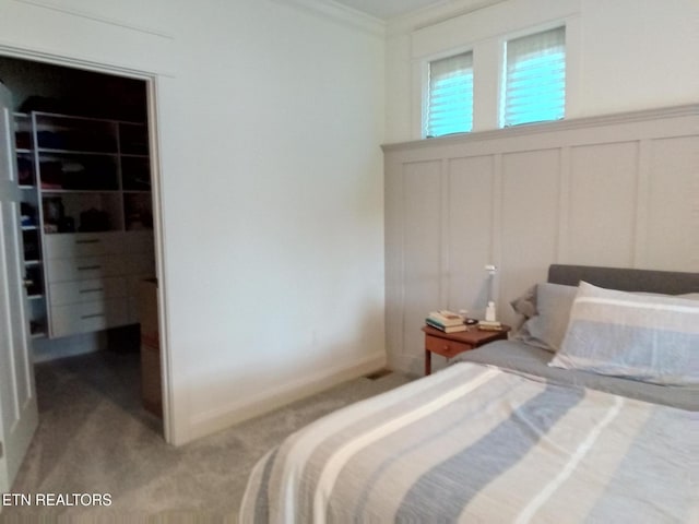 115 Bent Oak Ter, Crossville, TN 38558 - bedroom featuring a spacious closet, light colored carpet, crown molding, a decorative wall, and a closet