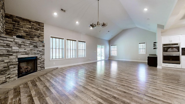 1012 Michaela Cir, Clarksville, TN 37043 - unfurnished living room featuring light wood-style floors, high vaulted ceiling, and a stone fireplace