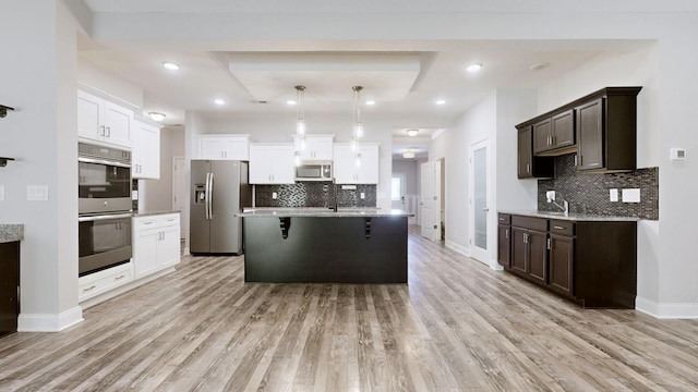 1012 Michaela Cir, Clarksville, TN 37043 - kitchen featuring stainless steel appliances, dark brown cabinets, tasteful backsplash, light wood finished floors, and recessed lighting