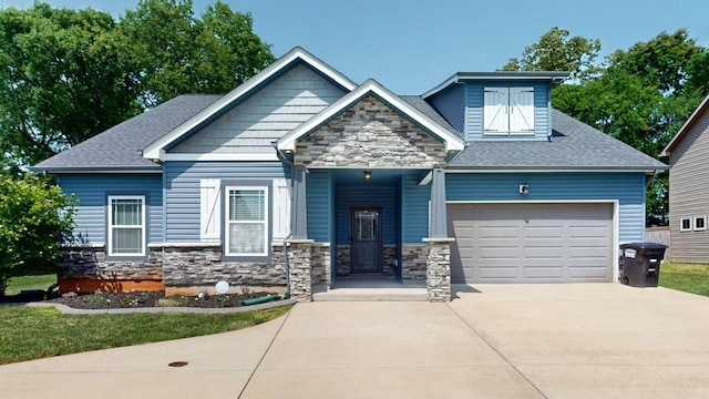 1012 Michaela Cir, Clarksville, TN 37043 - craftsman-style house with stone siding, a garage, driveway, and roof with shingles