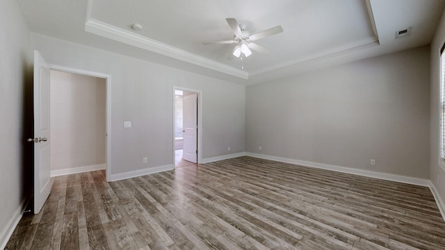 1012 Michaela Cir, Clarksville, TN 37043 - empty room with a tray ceiling, a ceiling fan, crown molding, and wood finished floors