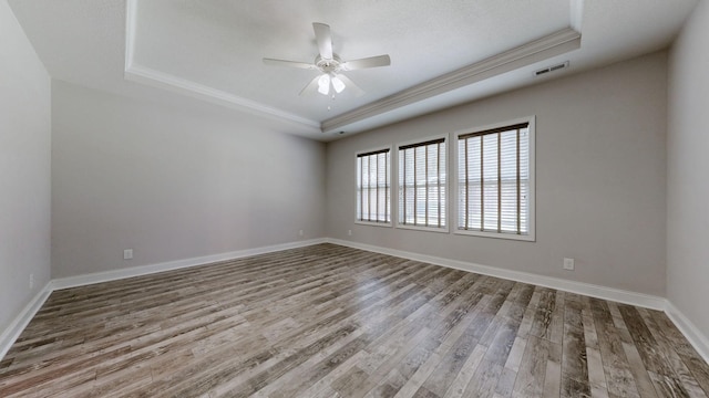 1012 Michaela Cir, Clarksville, TN 37043 - empty room with a tray ceiling, a ceiling fan, wood finished floors, and crown molding