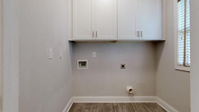 1012 Michaela Cir, Clarksville, TN 37043 - washroom featuring electric dryer hookup, washer hookup, wood finished floors, and cabinet space