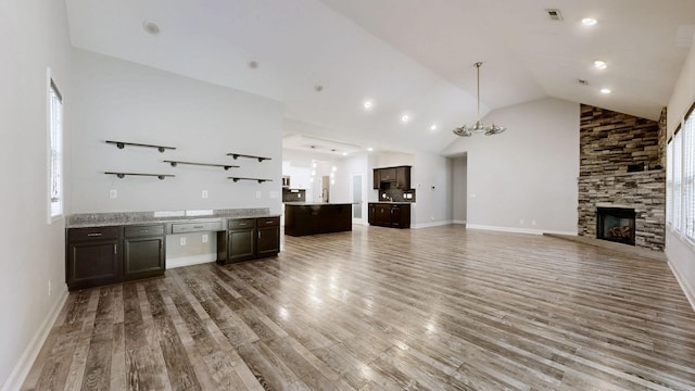 1012 Michaela Cir, Clarksville, TN 37043 - unfurnished living room featuring vaulted ceiling, light wood-style flooring, and a fireplace