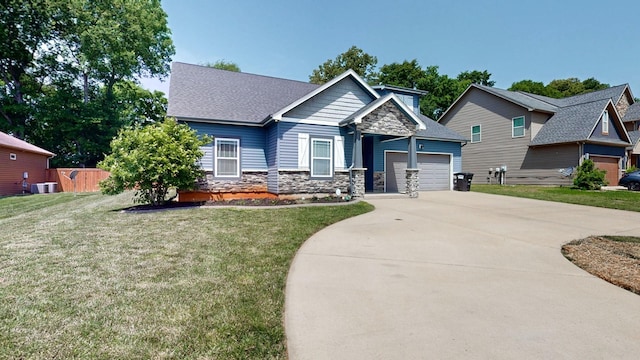 1012 Michaela Cir, Clarksville, TN 37043 - craftsman house featuring stone siding, concrete driveway, an attached garage, a front yard, and roof with shingles