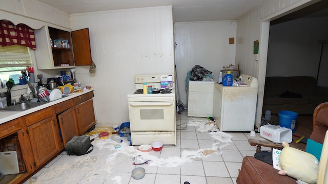606 E Church St, Kenton, TN 38233 - kitchen with white range, light countertops, brown cabinetry, washer and dryer, and open shelves