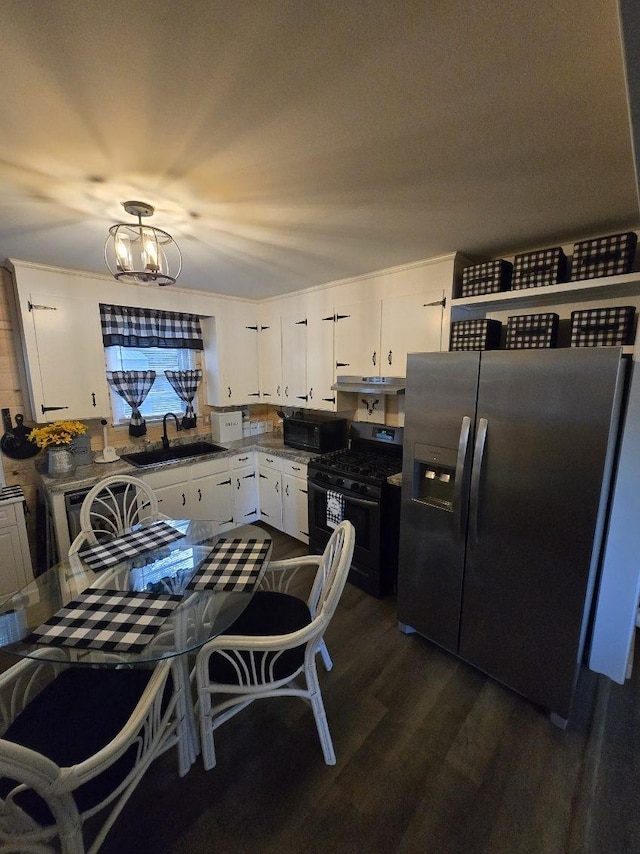 117 June Dr, Dickson, TN 37055 - kitchen with appliances with stainless steel finishes, white cabinets, dark wood-style flooring, and a chandelier