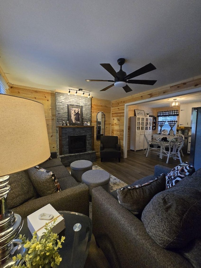 117 June Dr, Dickson, TN 37055 - living area featuring wood walls, wood finished floors, ceiling fan, and a stone fireplace