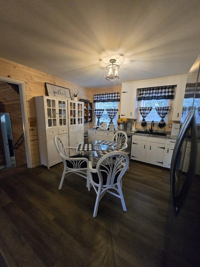 117 June Dr, Dickson, TN 37055 - dining space featuring wood walls, dark wood finished floors, and a chandelier