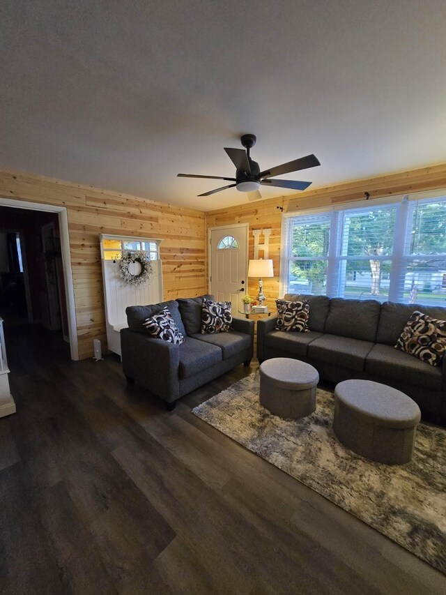 117 June Dr, Dickson, TN 37055 - living area featuring wood walls, a ceiling fan, and dark wood-type flooring