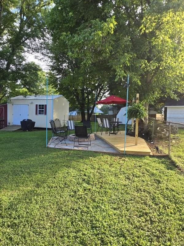 117 June Dr, Dickson, TN 37055 - view of yard with a storage unit, a wooden deck, and a patio