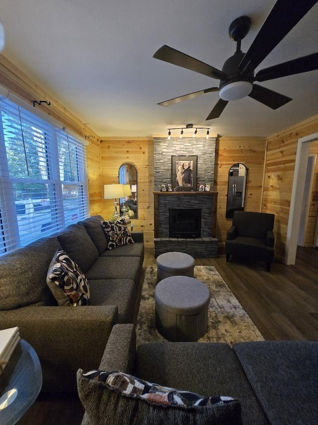 117 June Dr, Dickson, TN 37055 - living room with wooden walls, wood finished floors, a ceiling fan, and a fireplace