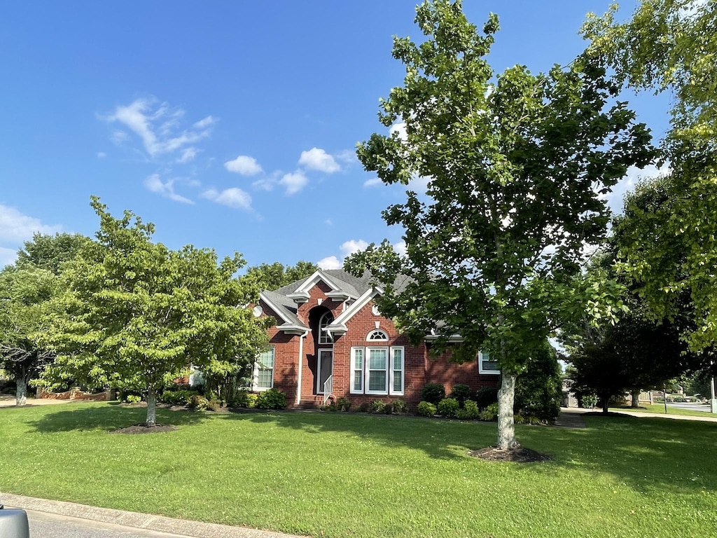 387 Natchez Trace Ct, Murfreesboro, TN 37127 - view of property hidden behind natural elements featuring a front lawn and brick siding