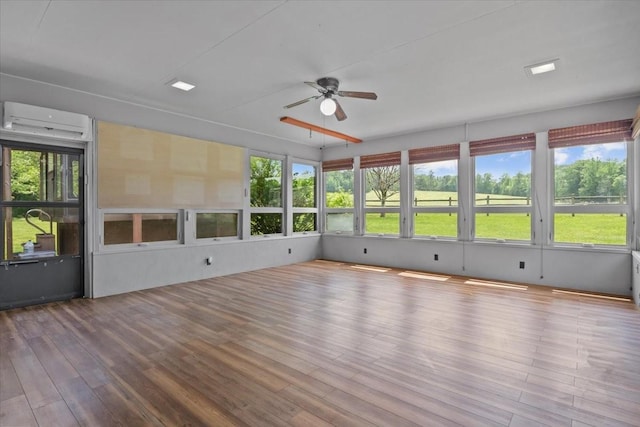 428 Gwin Cemetery Rd, Waverly, TN 37185 - unfurnished sunroom featuring a wall mounted air conditioner, ceiling fan, healthy amount of natural light, and wood finished floors