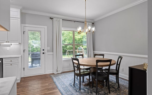 8366 Gracie Mac Ln, Ooltewah, TN 37363 - dining room with plenty of natural light, a wainscoted wall, dark wood-style flooring, a chandelier, and ornamental molding