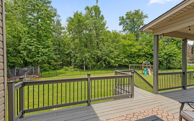 8366 Gracie Mac Ln, Ooltewah, TN 37363 - wooden terrace featuring a trampoline, a playground, and a fenced backyard