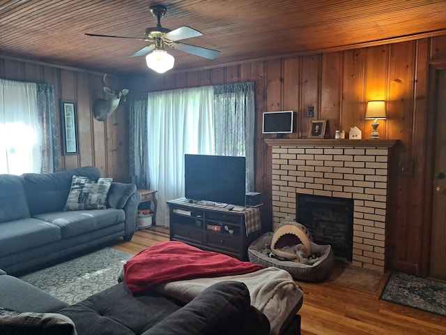 808 Days Rd, Lafayette, TN 37083 - living room with wood finished floors, wooden ceiling, a brick fireplace, wood walls, and ceiling fan