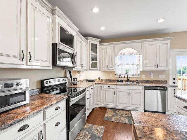 8300 Aedc Rd, Estill Springs, TN 37330 - kitchen with appliances with stainless steel finishes, white cabinets, dark wood-style flooring, and recessed lighting