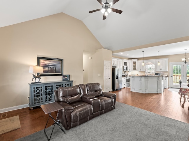 8300 Aedc Rd, Estill Springs, TN 37330 - living room with a ceiling fan, wood finished floors, high vaulted ceiling, and a chandelier