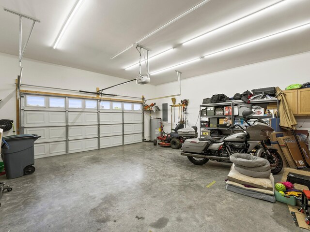 8300 Aedc Rd, Estill Springs, TN 37330 - garage featuring water heater, a garage door opener, and electric panel