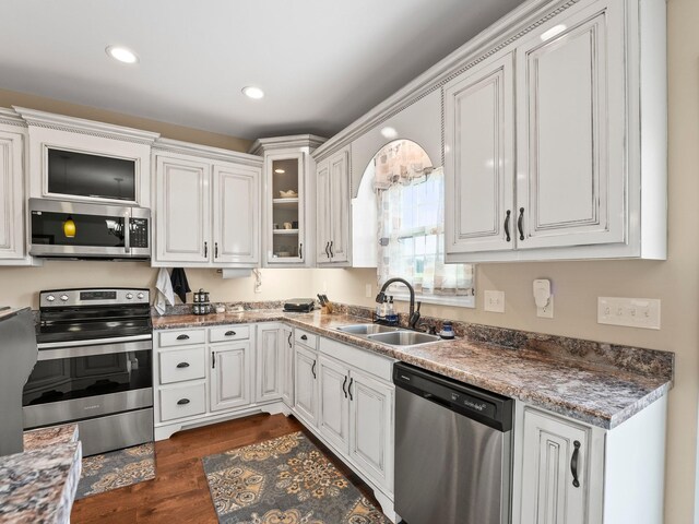 8300 Aedc Rd, Estill Springs, TN 37330 - kitchen featuring appliances with stainless steel finishes, white cabinets, dark wood finished floors, glass insert cabinets, and recessed lighting