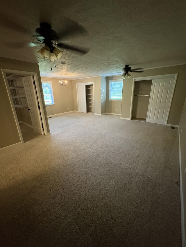 310 Lynwood Cir, Springfield, TN 37172 - unfurnished bedroom featuring a chandelier, carpet, multiple closets, and a ceiling fan
