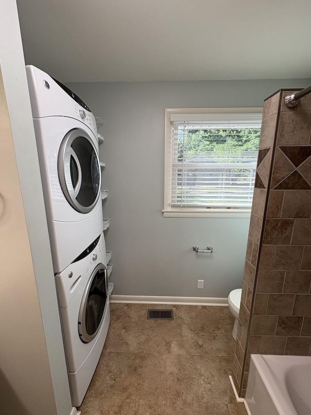 310 Lynwood Cir, Springfield, TN 37172 - washroom featuring stacked washer / dryer and baseboards