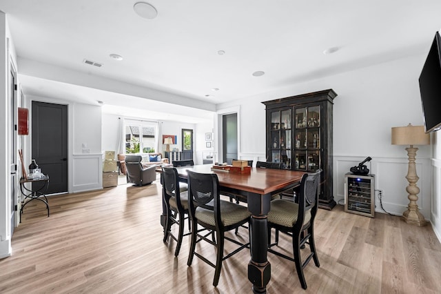 1526 Lipscomb Dr, Brentwood, TN 37027 - dining area featuring wine cooler, light wood-style flooring, and a wainscoted wall