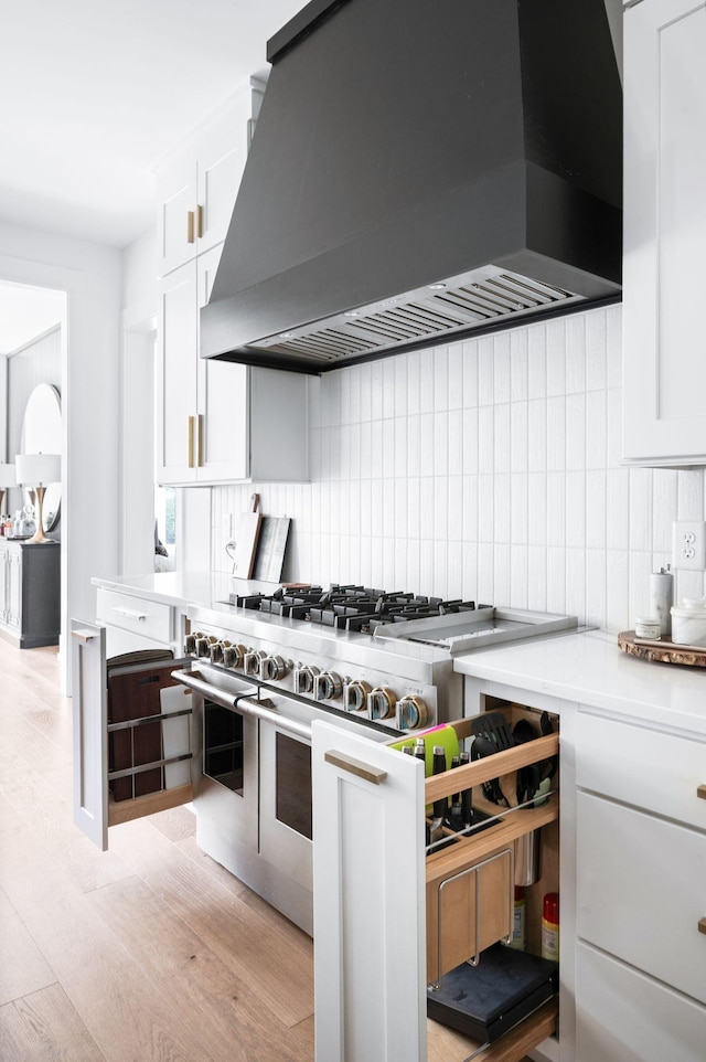 1526 Lipscomb Dr, Brentwood, TN 37027 - kitchen featuring custom exhaust hood, double oven range, tasteful backsplash, white cabinetry, and light wood finished floors