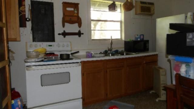 106 Log Home Ln, Moss, TN 38575 - kitchen featuring white electric range oven, brown cabinets, and light countertops