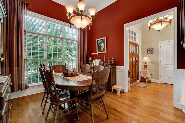 7003 Neville Dr, Ooltewah, TN 37363 - dining room with a chandelier, light wood-style floors, and crown molding