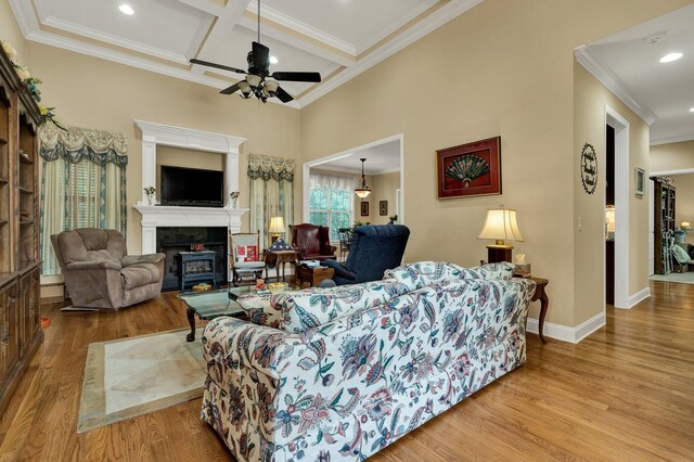7003 Neville Dr, Ooltewah, TN 37363 - living area with crown molding, wood finished floors, a ceiling fan, coffered ceiling, and a fireplace