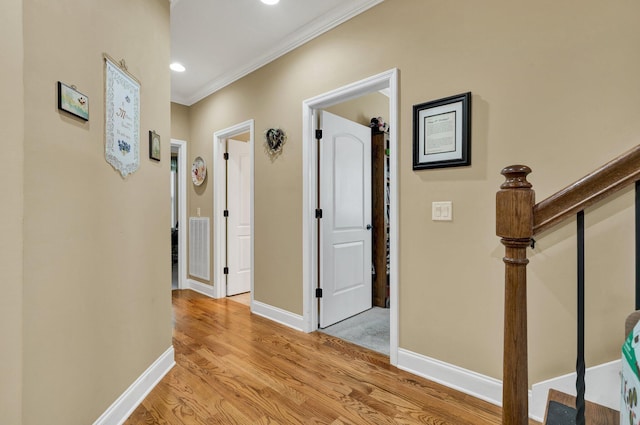 7003 Neville Dr, Ooltewah, TN 37363 - hallway featuring light wood-type flooring, crown molding, and stairway