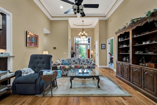 7003 Neville Dr, Ooltewah, TN 37363 - living room with ceiling fan, light wood-type flooring, a chandelier, crown molding, and a high ceiling