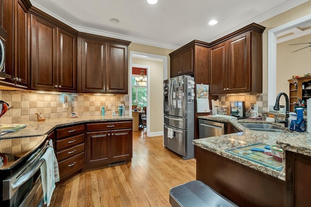 7003 Neville Dr, Ooltewah, TN 37363 - kitchen with stainless steel appliances, light stone countertops, light wood-type flooring, backsplash, and ornamental molding