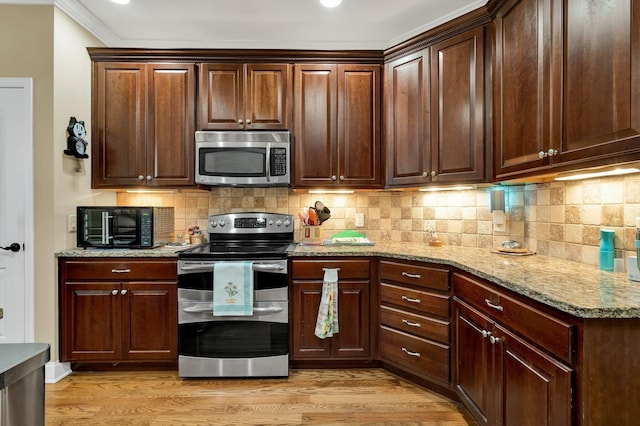 7003 Neville Dr, Ooltewah, TN 37363 - kitchen featuring appliances with stainless steel finishes, light wood-style floors, backsplash, light stone counters, and recessed lighting