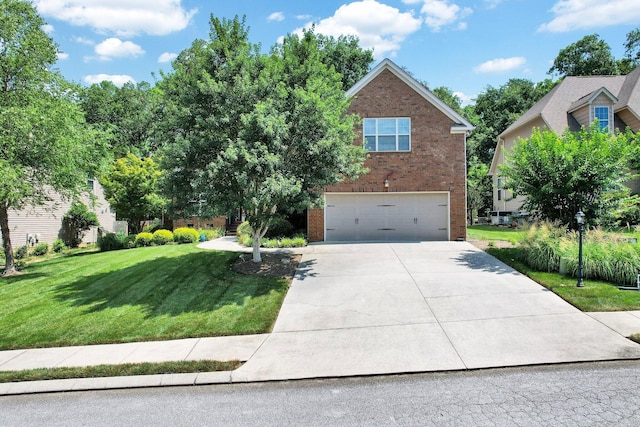 7003 Neville Dr, Ooltewah, TN 37363 - view of front facade with brick siding, a garage, driveway, and a front lawn