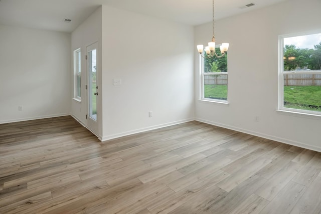 217 Summerlin Dr, Gallatin, TN 37066 - unfurnished room with a chandelier, healthy amount of natural light, and light wood finished floors