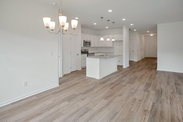 217 Summerlin Dr, Gallatin, TN 37066 - kitchen with stainless steel appliances, recessed lighting, white cabinets, light wood-style floors, and a kitchen island with sink