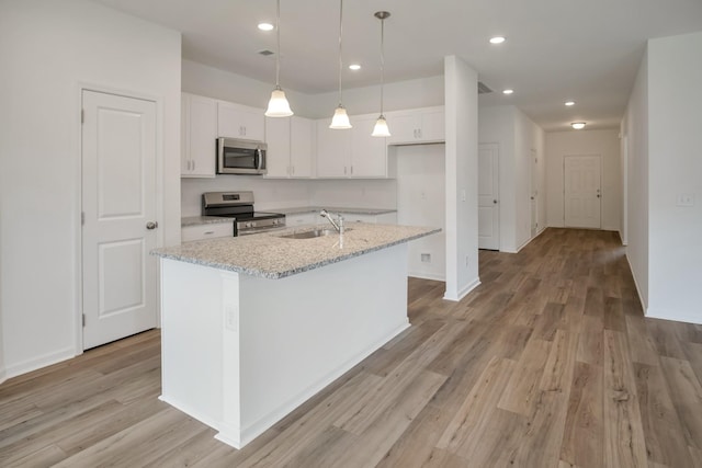 217 Summerlin Dr, Gallatin, TN 37066 - kitchen with stainless steel appliances, white cabinets, light wood-style floors, and recessed lighting