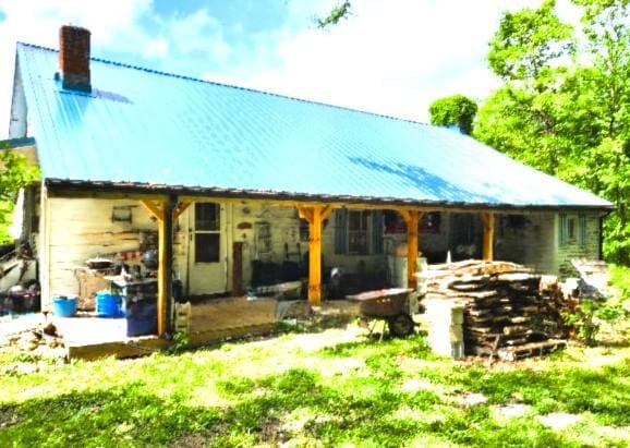 105 Log Home Ln, Moss, TN 38575 - back of property featuring a chimney and a metal roof